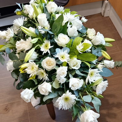 Peace and white - A selection of lillies, rose's,spider chrysanthemum white roses make this casket spray wonderful presence on any casket